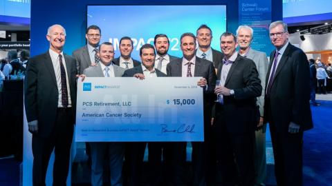 Men holding large sized check for winning the Best-in-Retirement Business IMPACT Award™